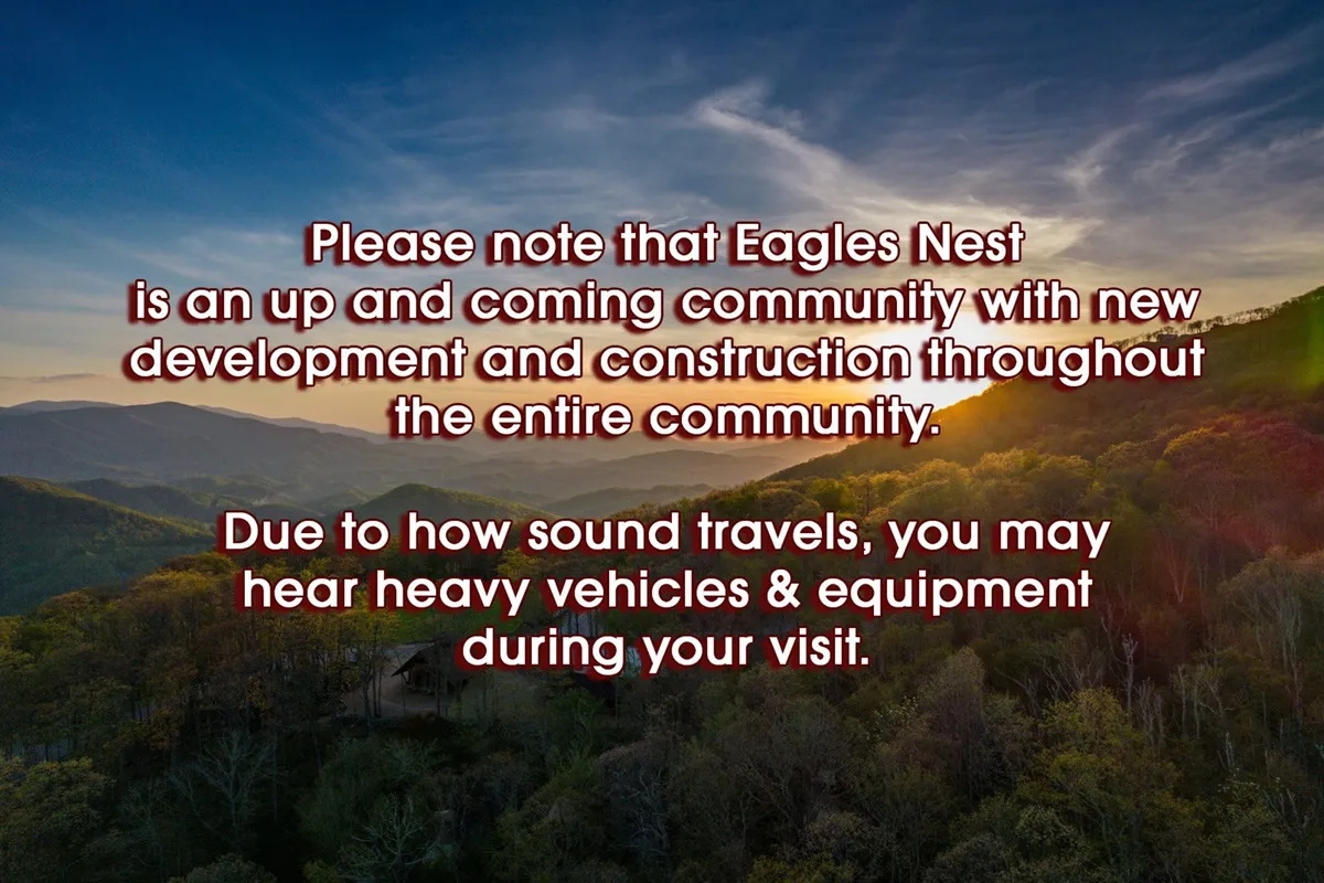 A panoramic view of the Blue Ridge Mountains, with layers of mountain ranges receding into the distance under a vibrant sunset sky, framed by lush greenery in the foreground. The scene is tranquil, showcasing the natural beauty of the retreat's setting.
